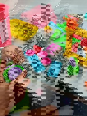 young person working with sticklebricks