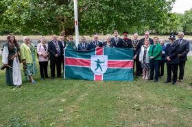 Chairman and invited guests posing with Nottinghamshire flag