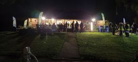 participants taking part in Shadow event outside building at night